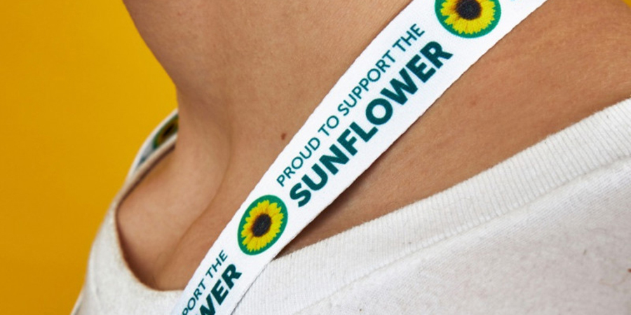 A people is wearing the sunflower lanyard